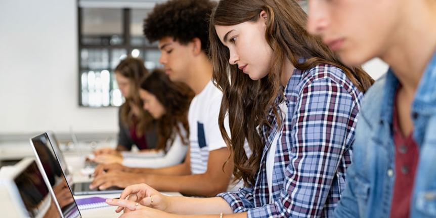 Students in classroom using laptop computers